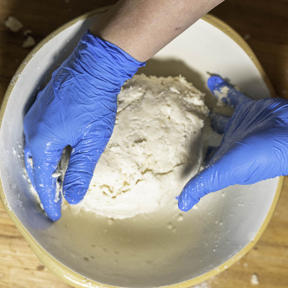 photo of a strawberry rhubarb pie hands mixing crust dough