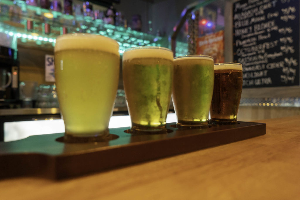 photo of four glasses of beer on dysart's bar