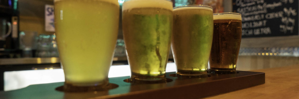 photo of four glasses of beer on dysart's bar