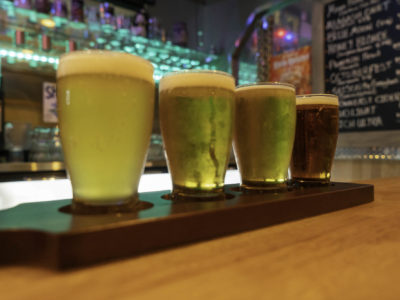 photo of four glasses of beer on dysart's bar