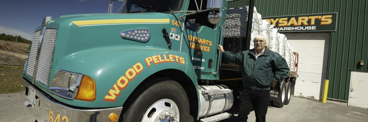 photo of man standing next to dysart's service wood pellets truck