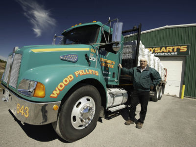 photo of man standing next to dysart's service wood pellets truck