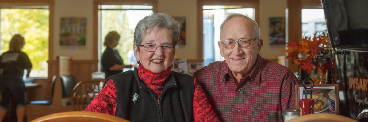 photo of elderly man and woman sitting at a Dysart's table