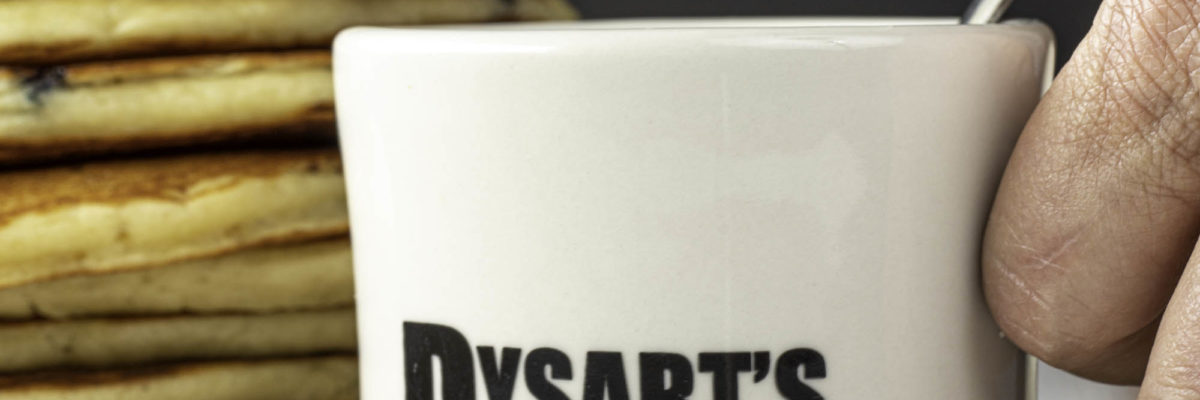 photo of dysart's restaurant coffee mug in front of stack of pancakes