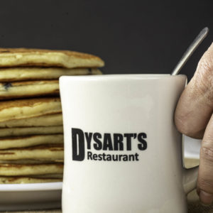 photo of dysart's restaurant coffee mug in front of stack of pancakes