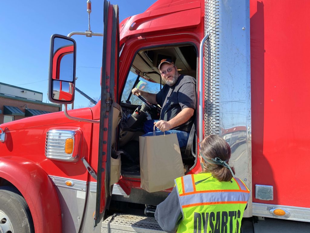 Curbside Delivery woman handing trucker bag of food